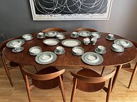 Full view of the 41-piece vintage Simpson (Potters) Ltd. chinastyle dinnerware set arranged on a wood dining table for 6.