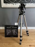 Manfrotto ART 074 tripod with Model 136 attachment standing upright next to the Ansel Adams book on the floor.