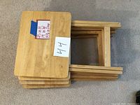 Four wooden TV trays stacked showing the tops and approximate measurements.