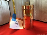 Front view of polished copper coffee canister with lid and brass plaque labeled COFFEE.