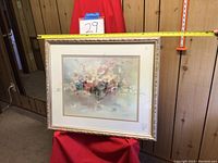 Front of framed floral print artwork showing the pastel flower bouquet and ornate light frame with measuring tape spanning width