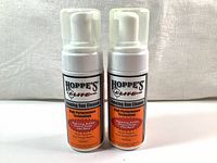 Two new white bottles of Hoppe's Elite Foaming Gun Cleaner with foaming pump tops, labels showing high performance technology and intended use for black powder residue removal.