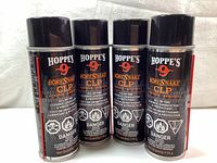 Four cans of Hoppe's 9 Bore Snake CLP aerosol cleaner, lubricant, and protectant, showing front labels with brand and usage information.