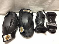 Four-piece protective gear set: two knee pads and two wrist braces displayed on white background.