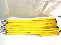Top view of 10 yellow flat polyester lanyards arranged side by side showing swivel hooks at one end.