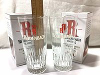 Pair of Rodenbach Classic beer glasses in front of their original boxes with a ruler showing height of glasses.
