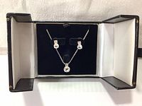 Jewelry gift box displaying matching earring and necklace set with Swarovski crystals and white rhodium plating