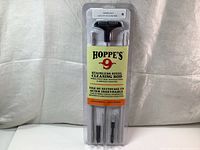 Photo showing full front view of new sealed Hoppe's 9 stainless steel three-piece cleaning rod in clear packaging with label