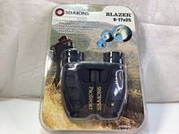 Front view of new sealed Simmons Blazer 8-17x25 ProSport binoculars in original blister packaging showing product branding and features