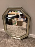 Full front view of the octagonal mirror showing its size and frame style against wall.