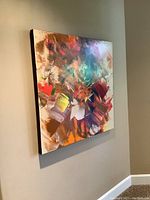 Large 36x36-inch abstract canvas with multicolored brushstrokes mounted on a wall.