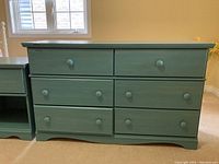 Full front view of painted wood dresser showing six drawers and flat top.