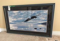 Full view of the framed print showing bald eagle soaring over water, with matting and frame in good condition.