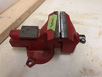 Front angled view focusing on vise jaws and handle with measurement notes on tape