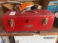 Front view of red Sears Craftsman steel tool box with handle and dual latches, showing visible wear and scuffs.