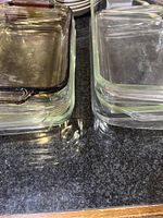 Top angled view showing stacked rectangular Pyrex dishes with visible glass transparency and rounded edges.