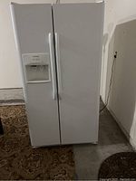 Front view closed showing white side-by-side refrigerator with ice and water dispenser