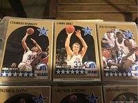 Close-up of six NBA Hoops basketball cards featuring Charles Barkley, Larry Bird, Joe Dumars, Patrick Ewing, Michael Jordan, and Kevin McHale.