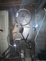 Full view of women's bicycle without front tire showing frame, rear wheel, handlebars, and pedals.