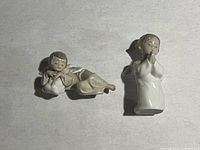 Both Lladró porcelain angel figurines shown side by side on a flat surface.