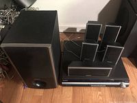 Full view of Sony surround sound components showing subwoofer, receiver, and five satellite speakers