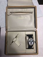 TechnoMarine watch in beige box showing watch, strap, and watch winding tool.