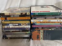 Two stacks of DVDs and Blu-rays showing titles like Wuthering Heights, Dog Day Afternoon, Boogie Nights, Cleopatra, Spartacus, and a box set titled The Martin Scorsese Film Collection.