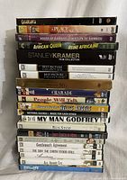 Stack of 20 DVD movies vertically showing spines with titles including Casablanca, A Place in the Sun, House of Bamboo, The African Queen, Stanley Kramer Collection, Best Picture Collection, Charade, and more