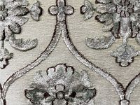 Close-up of textured floral medallion motif on beige background