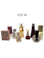 Photo shows front view of all nine fragrance bottles, some with boxes and decorative features