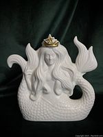 Front side showing detailed wavy hair, facial features, scaled tail, and gold crown with star.