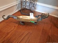 Full view of elongated dragon dish on wood floor
