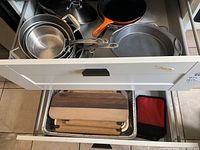 Drawer containing assorted pots, pans, cutting boards and bakeware