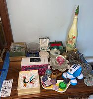 Full view of all items including jewelry, pens, glass figurine, trinket dishes, and decorative ornaments.