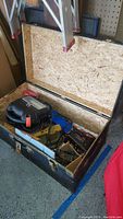 Open chest showing contents of tools including Black & Decker sanders and scroll saw.