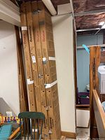 Four upright cardboard boxes of Armstrong and Bruce branded solid hardwood flooring leaning against a wall