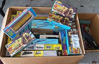 Top view box with multiple Athearn train boxes, Model Power train model box, and Bachmann tracks visible