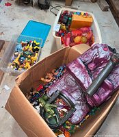 Box with purple fortress section and mixed action figures