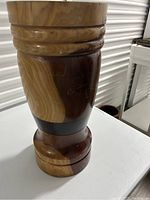 Front view showing natural wood grain and carved ridges on the planter