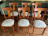 All six chairs arranged in two rows on parquet floor