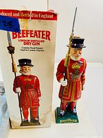 Beefeater Yeoman ceramic figure displayed alongside its original box with branding and images of the figure.