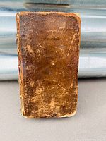 Front cover view showing leather surface wear and edge rubbing