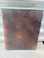 Front cover of brown leather binding with surface scuffs and wear spots