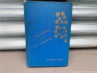 Front cover of the book showing the title 'The Legends of the St. Lawrence' along with a gold embossed maple leaf design and author name Sir James M. Le Moine.