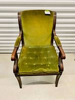 Front view of antique Empire style walnut armchair with green crushed velvet upholstery.