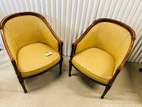 Front view of both chairs showing shape, upholstery and frame detail