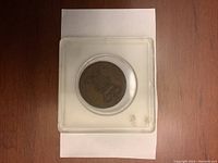 Front side of 1803 Bavarian Pfennig coin showing crowned emblem in plastic case