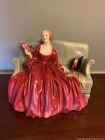 Full front view of the figurine on a wooden surface.