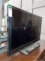 42 inch Sharp Aquos LED TV complete front and side view showing overall size and condition.