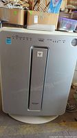 Front view of the silver Sharp air purifier unit with control panel and indicators.